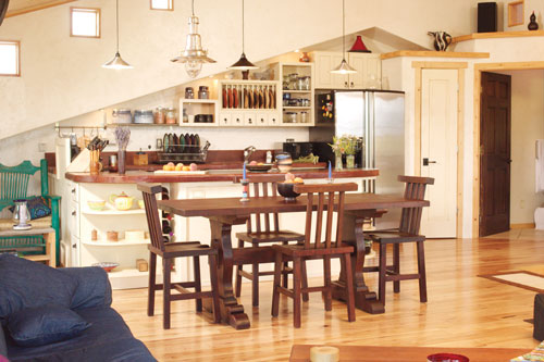 In designing the great room, Emmanuelle and Bradley sought to create an open space where friends could gather. Dark coffee stain gives the concrete countertops a leathery look. The table and chairs are a find from Mexico.